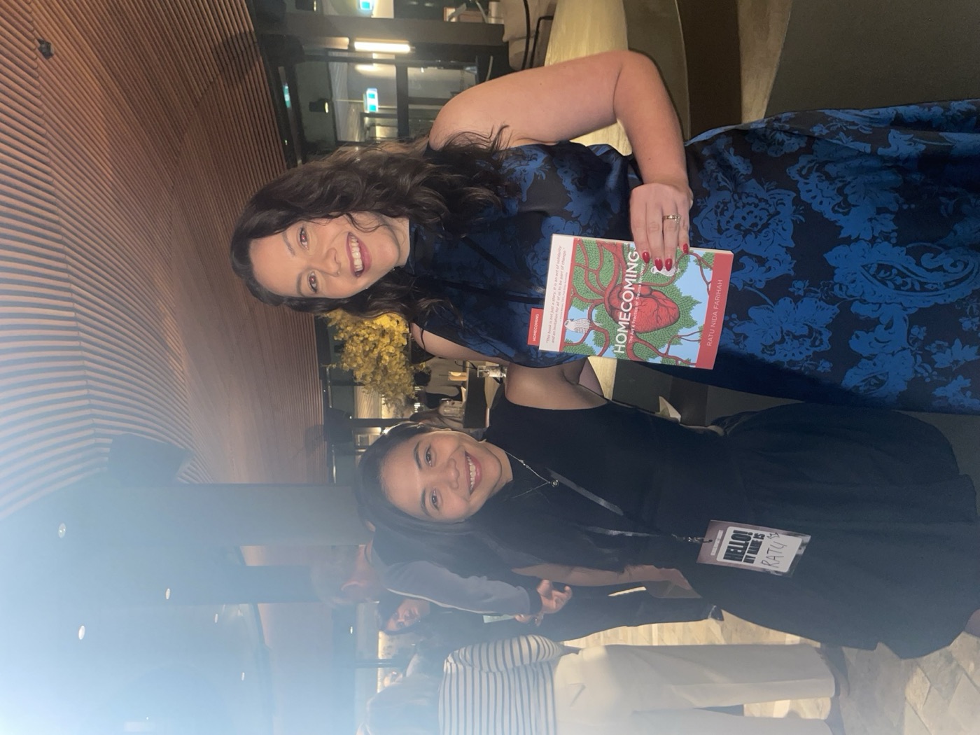 Ratu Nida beside an event guest holding Homecoming at a literary gathering