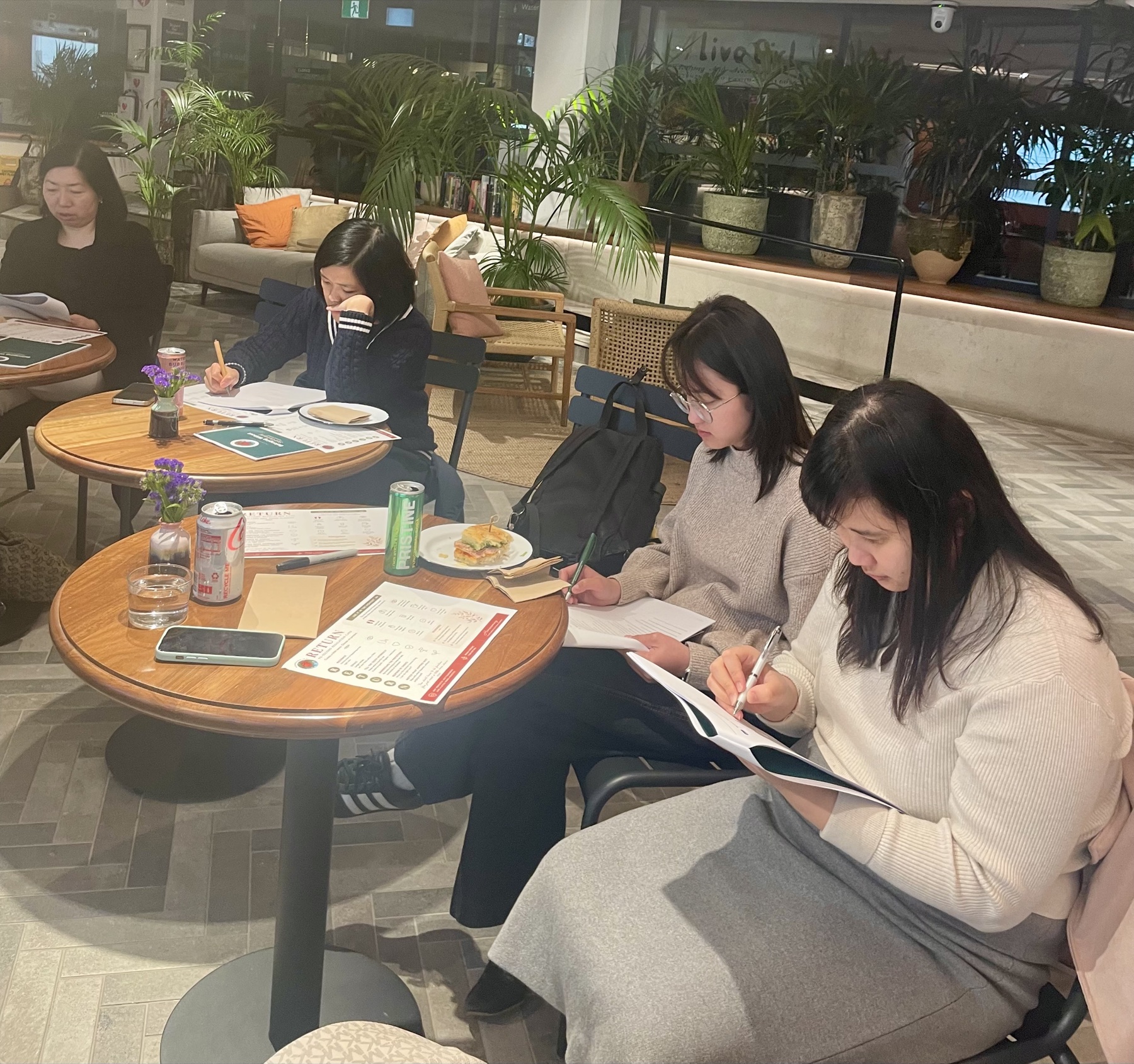 Workshop participants writing in their workbooks during a reflective exercise.