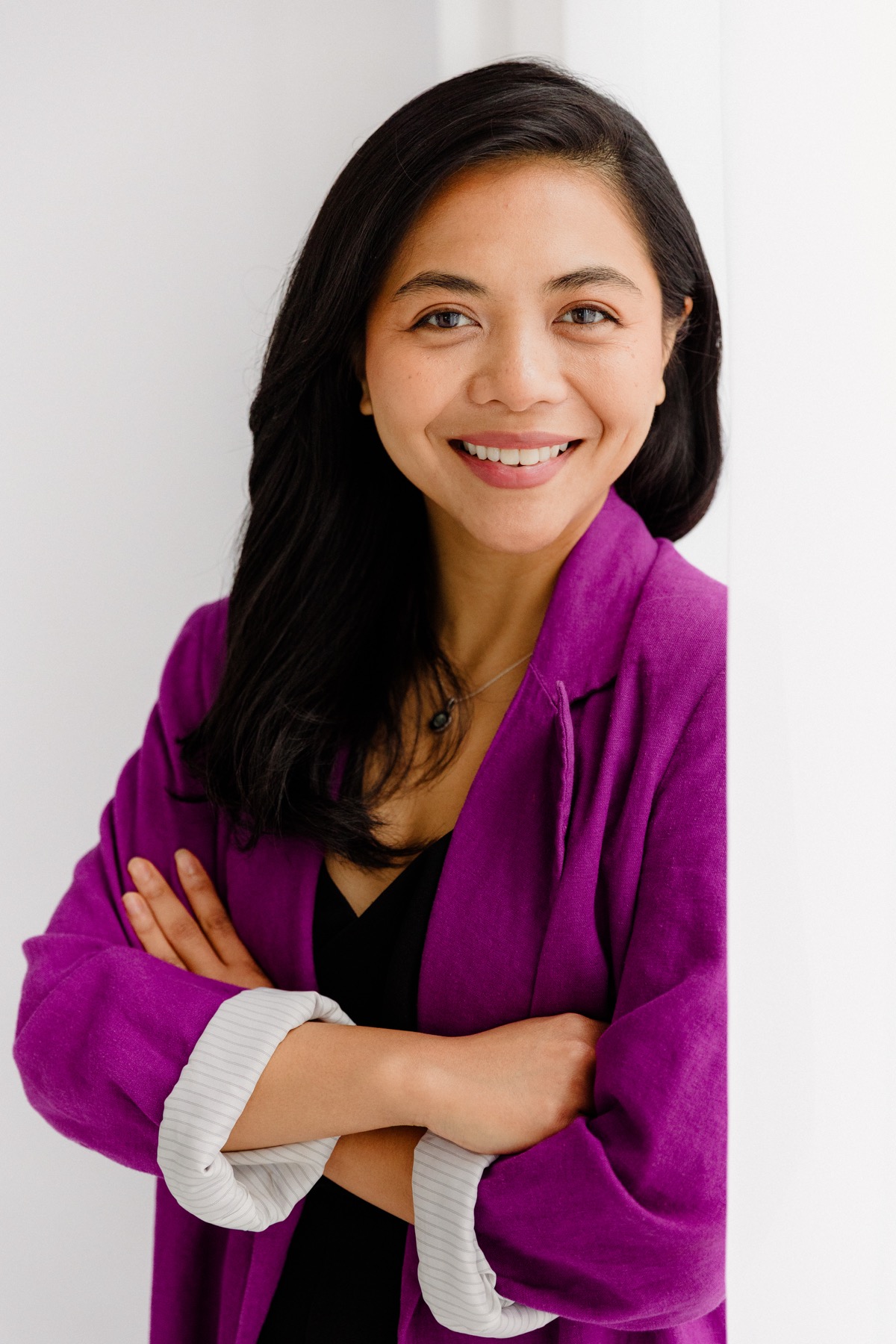 Ratu Nida portrait in a purple jacket for speaking and workshops