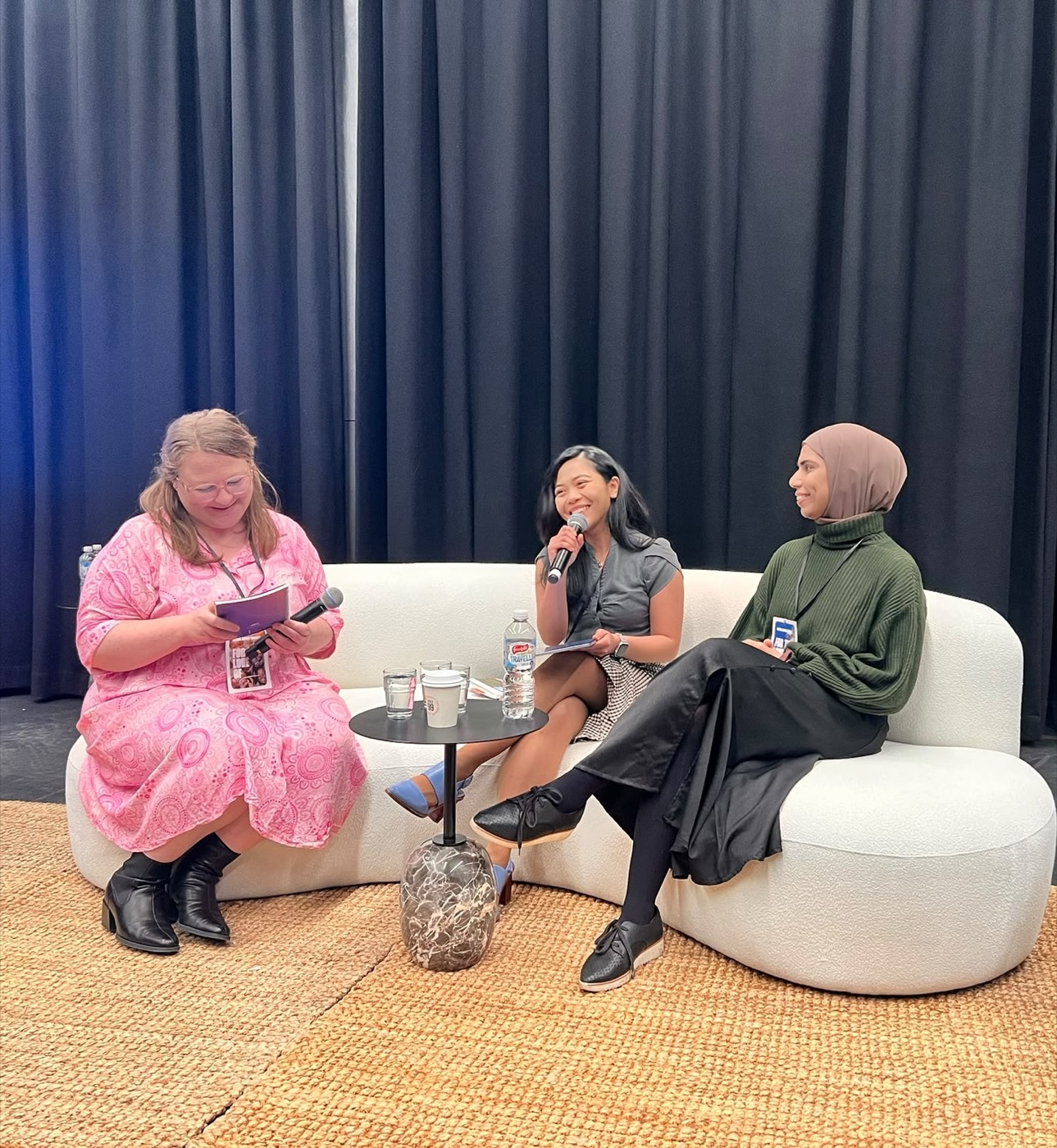 Ratu Nida speaking on stage with another panellist during a leadership and impact event.