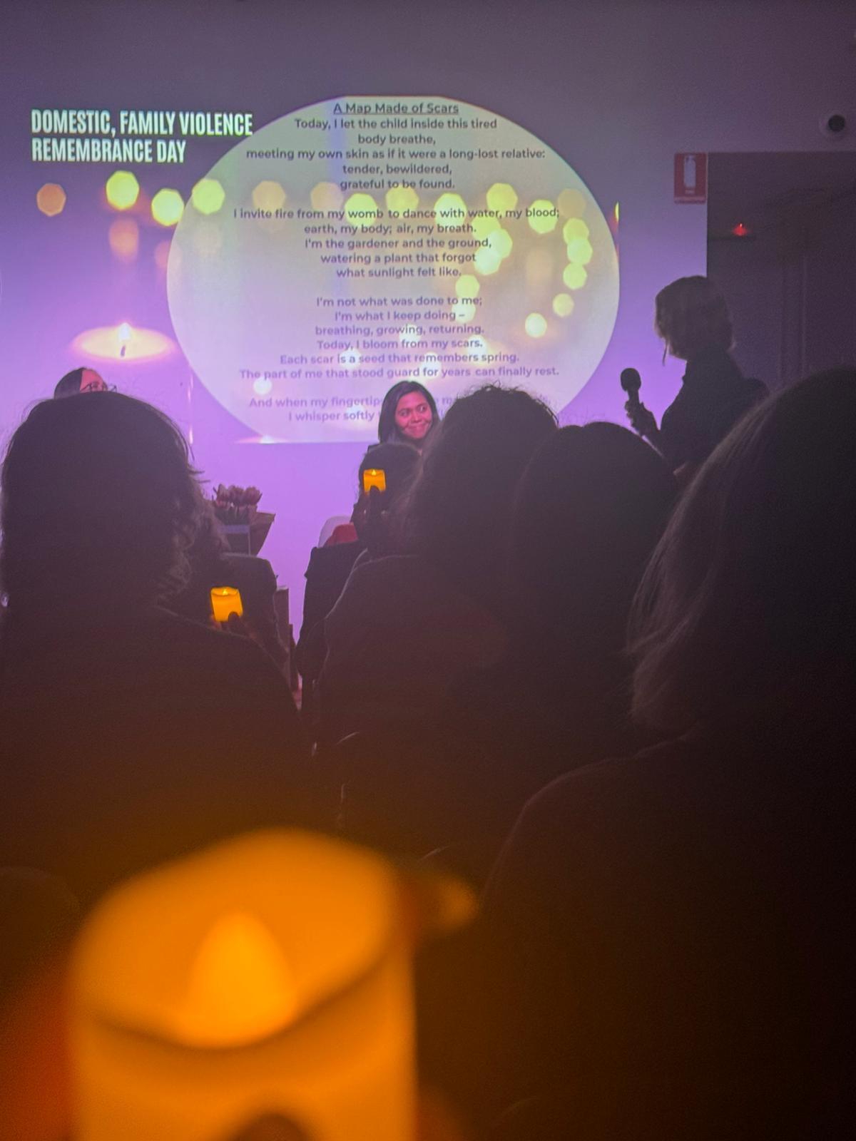 Domestic and family violence remembrance event with audience candlelight
